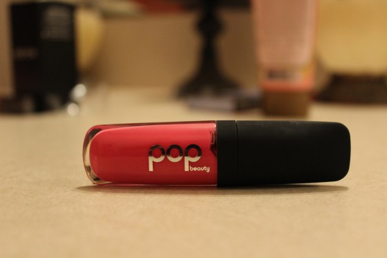 Pop Beauty -"Fuchsia Freesia" This mini gloss is perfect to throw in your bag and your'e out the door! The sheer tint is great over another color to mix or alone by itself for a natural flushed pink pout.  Although I did not see the advertised "plumping" effects I did feel the moisture from the avocado and jojoba oils used in said product. I love it! 